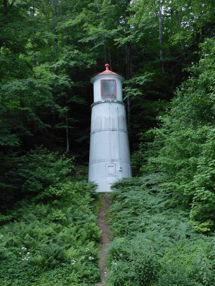 The Munising Rear Range Lighthouse stands tucked into a forested hillside, guiding ships through the East Channel of Lake Superior.