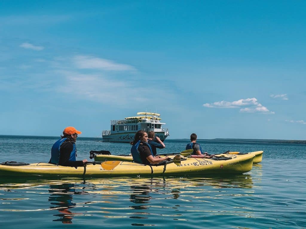 Pictured Rocks Kayaking on Lake Superior with boat nearby