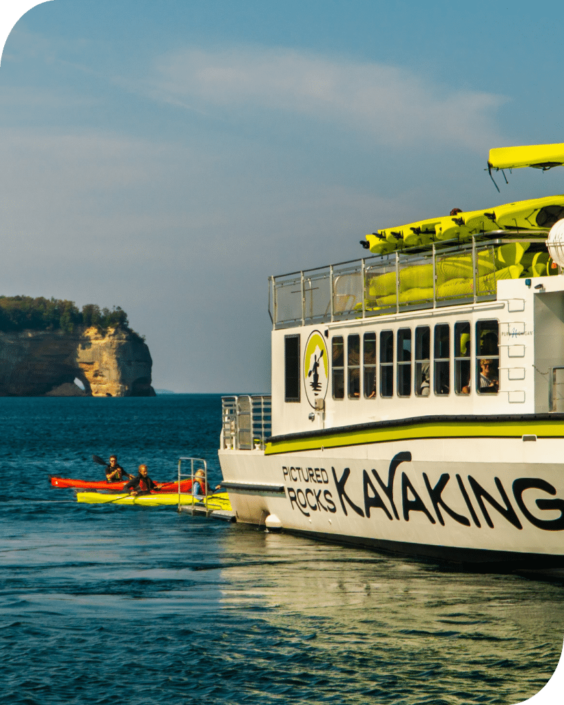 Pictured Rocks Kayaking boat drops kayakers off into Lake Superior